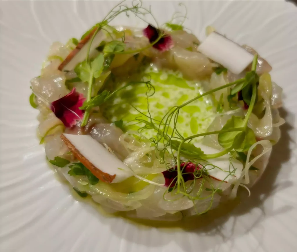 entrée représentant un tartare de poisson avec de la noix de coco, une création originale de giuseppe crespa