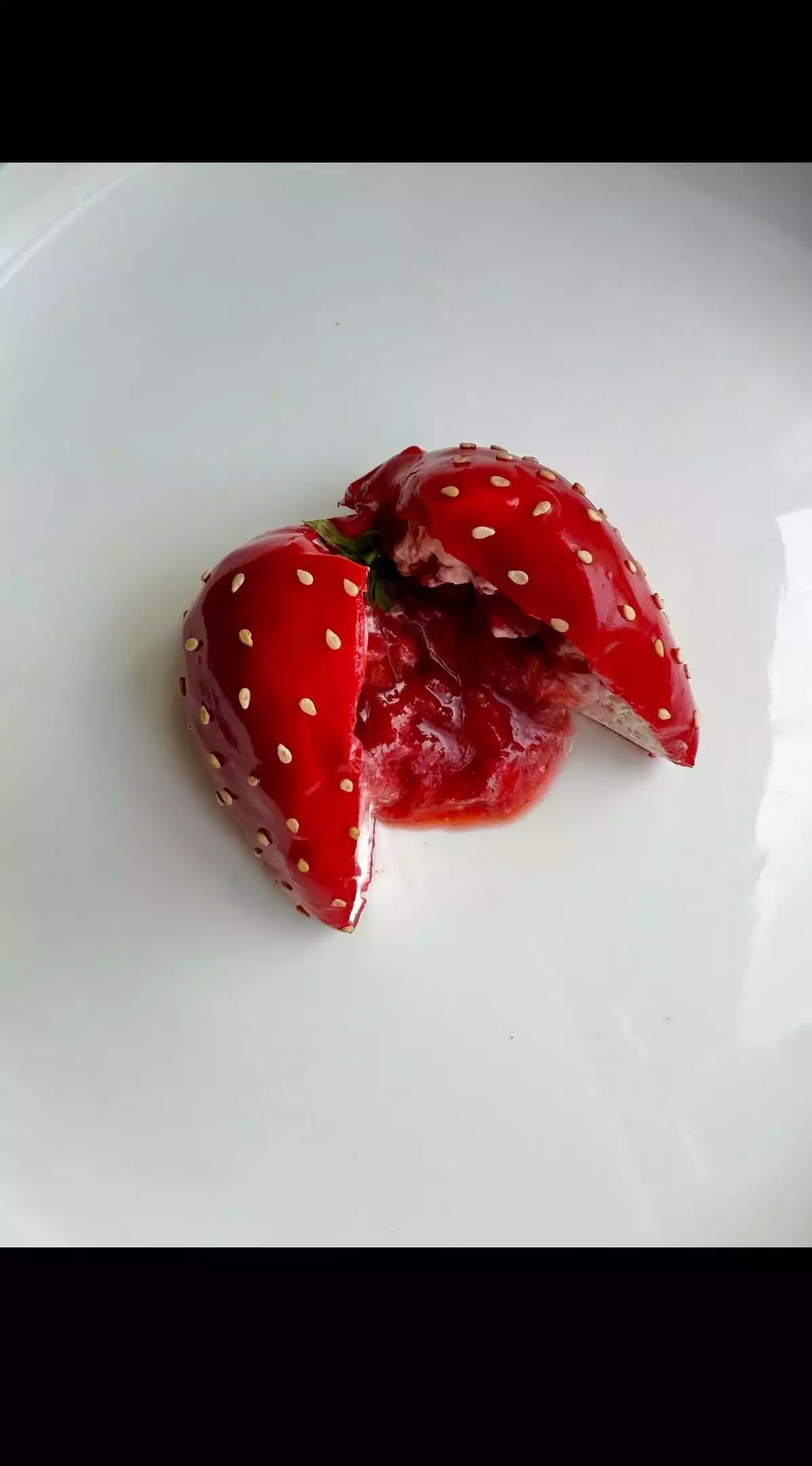 trompe l'oeil dessert of a strawberry with flowing heart created by chef théo moisan
